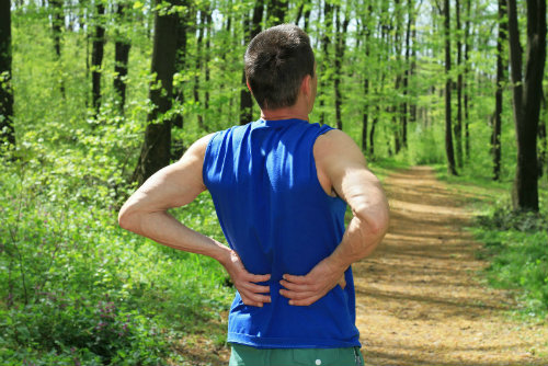 Man in pain after running before using a TENS unit